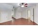 Comfortable bedroom with hardwood floors, multiple doors, and neutral-colored walls at 255 Beech Tree Holw, Sugar Hill, GA 30518