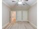 Carpeted bedroom with ceiling fan and multiple doors at 255 Beech Tree Holw, Sugar Hill, GA 30518