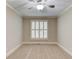 Neutral bedroom features carpeted floors, ceiling fan, and a bright window at 255 Beech Tree Holw, Sugar Hill, GA 30518