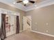 Carpeted bedroom features a ceiling fan, recessed lighting, and glass doors leading to another room at 255 Beech Tree Holw, Sugar Hill, GA 30518