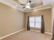 Neutral bedroom features a ceiling fan, recessed lighting, and a window with blinds and curtains at 255 Beech Tree Holw, Sugar Hill, GA 30518