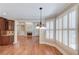 Breakfast nook with hardwood floors, large windows with shutters, and a view into the living room at 255 Beech Tree Holw, Sugar Hill, GA 30518