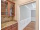 Butler's pantry featuring granite countertops, wooden cabinets, and stylish backsplash at 255 Beech Tree Holw, Sugar Hill, GA 30518