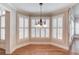 Bright dining area featuring hardwood floors, large windows with shutters, and a decorative chandelier at 255 Beech Tree Holw, Sugar Hill, GA 30518