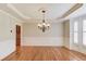 Elegant dining room featuring hardwood floors, wainscoting, and a decorative chandelier at 255 Beech Tree Holw, Sugar Hill, GA 30518