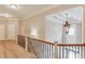Upstairs hallway featuring hardwood floors, railing and chandelier at 255 Beech Tree Holw, Sugar Hill, GA 30518