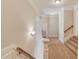 Bright hallway features carpet flooring, neutral walls and elegant lighting fixtures at 255 Beech Tree Holw, Sugar Hill, GA 30518