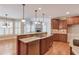 Open kitchen featuring an island, granite countertops, and stainless steel appliances at 255 Beech Tree Holw, Sugar Hill, GA 30518