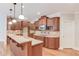 Spacious kitchen featuring an island with a sink, granite countertops, and wood cabinetry at 255 Beech Tree Holw, Sugar Hill, GA 30518