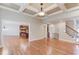 Open concept living room with hardwood floors and views into the kitchen and staircase at 255 Beech Tree Holw, Sugar Hill, GA 30518