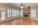 Bright living room with hardwood floors and a stunning stone fireplace at 255 Beech Tree Holw, Sugar Hill, GA 30518