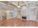 Open living area with hardwood floors, fireplace, built-ins, and staircase access to the second floor at 255 Beech Tree Holw, Sugar Hill, GA 30518