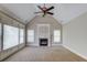 Charming living room features a fireplace, vaulted ceilings with a ceiling fan and many windows at 255 Beech Tree Holw, Sugar Hill, GA 30518