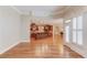 Open-concept living area with hardwood floors and a view into the kitchen at 255 Beech Tree Holw, Sugar Hill, GA 30518