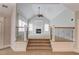 Open living room boasts a fireplace, large windows, and vaulted ceilings with a ceiling fan at 255 Beech Tree Holw, Sugar Hill, GA 30518