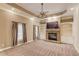 Inviting living room featuring a stone fireplace, built-in bookshelves, and ample natural light at 255 Beech Tree Holw, Sugar Hill, GA 30518