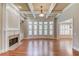 Bright living room with hardwood floors, fireplace, and large windows with plantation shutters at 255 Beech Tree Holw, Sugar Hill, GA 30518