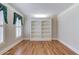 Bright office space with hardwood floors, built-in bookshelves, and plantation shutters at 255 Beech Tree Holw, Sugar Hill, GA 30518