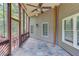 Covered porch features tile flooring, screens and views of the wooded yard at 255 Beech Tree Holw, Sugar Hill, GA 30518