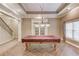 Large game room with a pool table, with convenient access to the staircase at 255 Beech Tree Holw, Sugar Hill, GA 30518