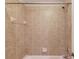 Close-up of a shower-tub combo with beige tiling, a showerhead, and a soap dish at 255 Beech Tree Holw, Sugar Hill, GA 30518