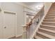 Elegant staircase with carpeted steps, iron spindles, and custom trim work at 255 Beech Tree Holw, Sugar Hill, GA 30518