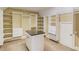 Spacious walk-in closet with custom shelving, drawers, and an island at 255 Beech Tree Holw, Sugar Hill, GA 30518