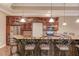Charming wet bar featuring stone countertops, stainless appliances, and barstool seating at 255 Beech Tree Holw, Sugar Hill, GA 30518
