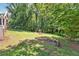 Sprawling backyard with a play area, fire pit, and garden, ideal for Gathering fun and outdoor living at 3248 Wildwood Sw Dr, Marietta, GA 30060