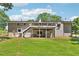 Home's exterior showcasing a multi-level deck overlooking a large backyard with a fire pit and well-maintained lawn at 3248 Wildwood Sw Dr, Marietta, GA 30060