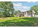 Spacious backyard featuring a fire pit, lush greenery, and mature trees for outdoor relaxation and entertainment at 3248 Wildwood Sw Dr, Marietta, GA 30060