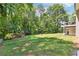 Expansive backyard with lush greenery, mature trees, playground, and seating area for outdoor enjoyment at 3248 Wildwood Sw Dr, Marietta, GA 30060