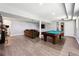 Entertainment basement features a pool table, couch, hardwood flooring and large television at 3248 Wildwood Sw Dr, Marietta, GA 30060