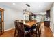 Open dining room view showcases the adjacent kitchen with stainless steel appliances and dark wood cabinets at 3248 Wildwood Sw Dr, Marietta, GA 30060