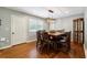 Dining room with a modern chandelier, hardwood floors, and a dining table with seating for six at 3248 Wildwood Sw Dr, Marietta, GA 30060
