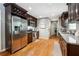 Well-lit kitchen with stainless steel appliances, granite counters, and stylish dark wood cabinetry at 3248 Wildwood Sw Dr, Marietta, GA 30060