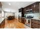 Spacious kitchen featuring stainless steel appliances, dark cabinets, and an adjoining dining area at 3248 Wildwood Sw Dr, Marietta, GA 30060