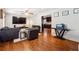 Spacious living room with hardwood floors, a large TV, and a glimpse of the adjacent kitchen at 3248 Wildwood Sw Dr, Marietta, GA 30060