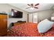 Cozy primary bedroom featuring a large bed with paisley patterned bedding, hardwood floors, and a ceiling fan at 3248 Wildwood Sw Dr, Marietta, GA 30060