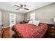 Spacious main bedroom featuring hardwood floors, large windows, ceiling fan, and ensuite bathroom at 3248 Wildwood Sw Dr, Marietta, GA 30060