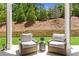 Covered back patio featuring comfortable seating and views of the private backyard at 4011 Fallen Leaf Ct, Kennesaw, GA 30152
