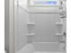Clean white shower-tub combo with built in shelving in bright bathroom at 4011 Fallen Leaf Ct, Kennesaw, GA 30152