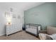 Stylish Bedroom with soothing colors, crib, changing table, and sitting chair at 4011 Fallen Leaf Ct, Kennesaw, GA 30152
