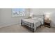 Bedroom with natural light from window, carpeted floor, and two bedside tables at 4011 Fallen Leaf Ct, Kennesaw, GA 30152