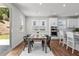 Dining area with natural light, wood flooring, and a view into the modern kitchen at 4011 Fallen Leaf Ct, Kennesaw, GA 30152