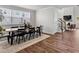 Stylish dining room with modern decor, neutral colors, and hardwood floors, adjacent to the living room at 4011 Fallen Leaf Ct, Kennesaw, GA 30152