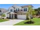 Charming two-story home featuring a stone facade, white siding, and an attached two-car garage at 4011 Fallen Leaf Ct, Kennesaw, GA 30152