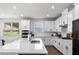 Modern kitchen features white cabinets, subway tile backsplash, and a spacious island with a sink at 4011 Fallen Leaf Ct, Kennesaw, GA 30152
