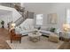 Spacious living room with neutral colors, hardwood floors, staircase and comfortable seating at 4011 Fallen Leaf Ct, Kennesaw, GA 30152