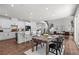 Open concept kitchen and living space featuring a breakfast bar, stairs, and natural light at 4011 Fallen Leaf Ct, Kennesaw, GA 30152
